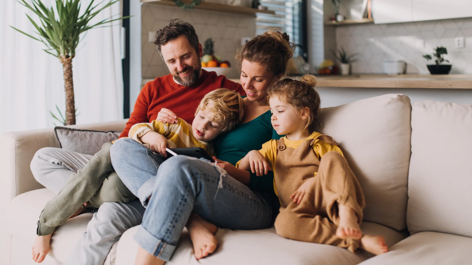 Happy family painting a wall together in their house