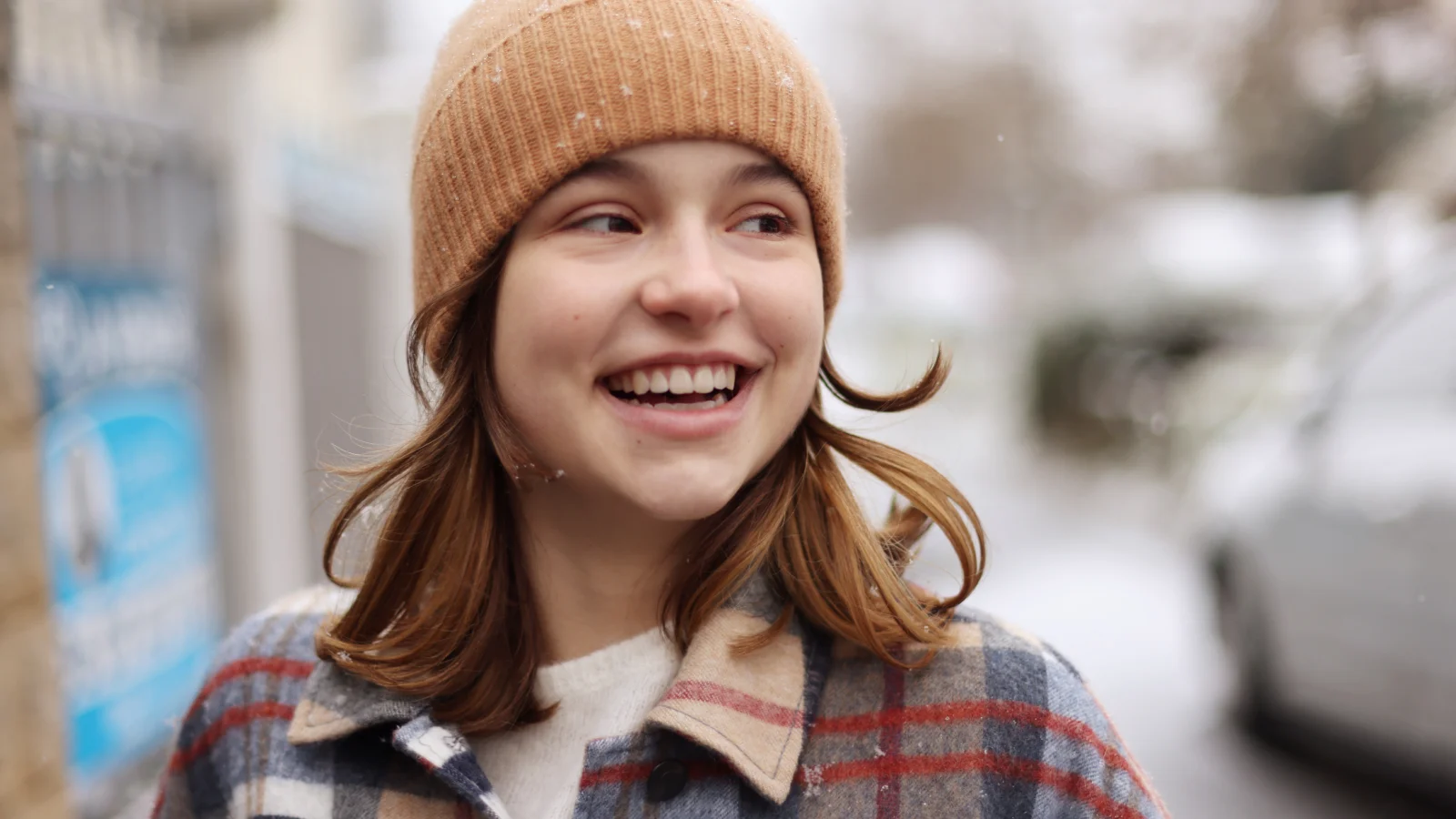 Girl smiling wearing a beanie