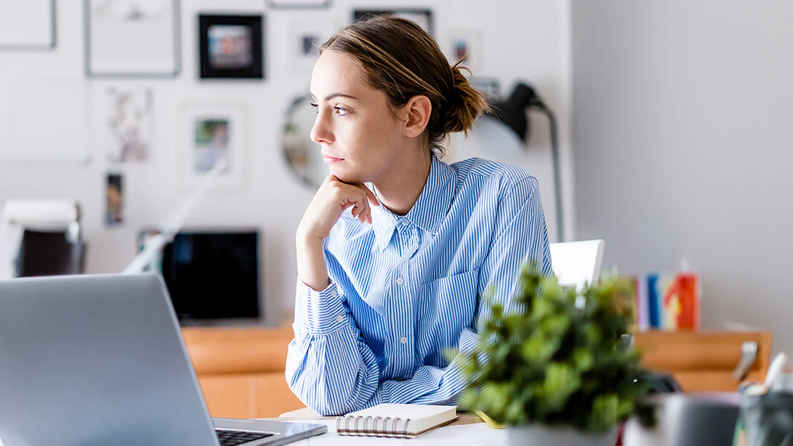 Mental wellness benefits - Woman looking out the window from her desk