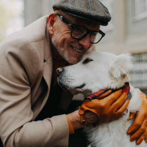 older-man-hugging-golden-retriever