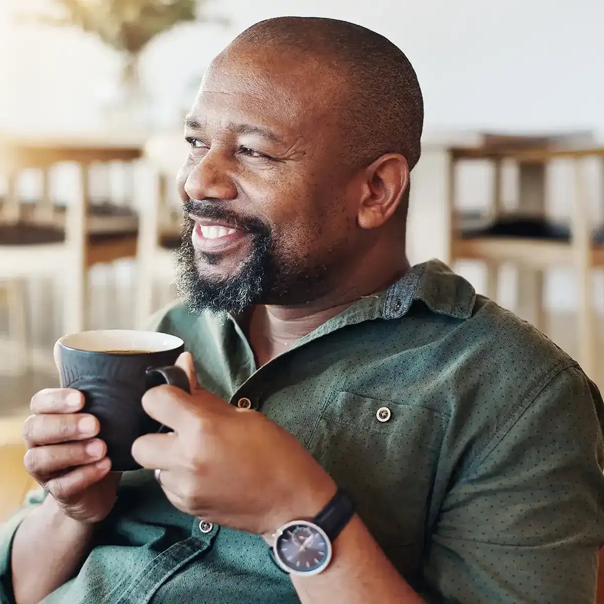 Man holding a cup of coffee.