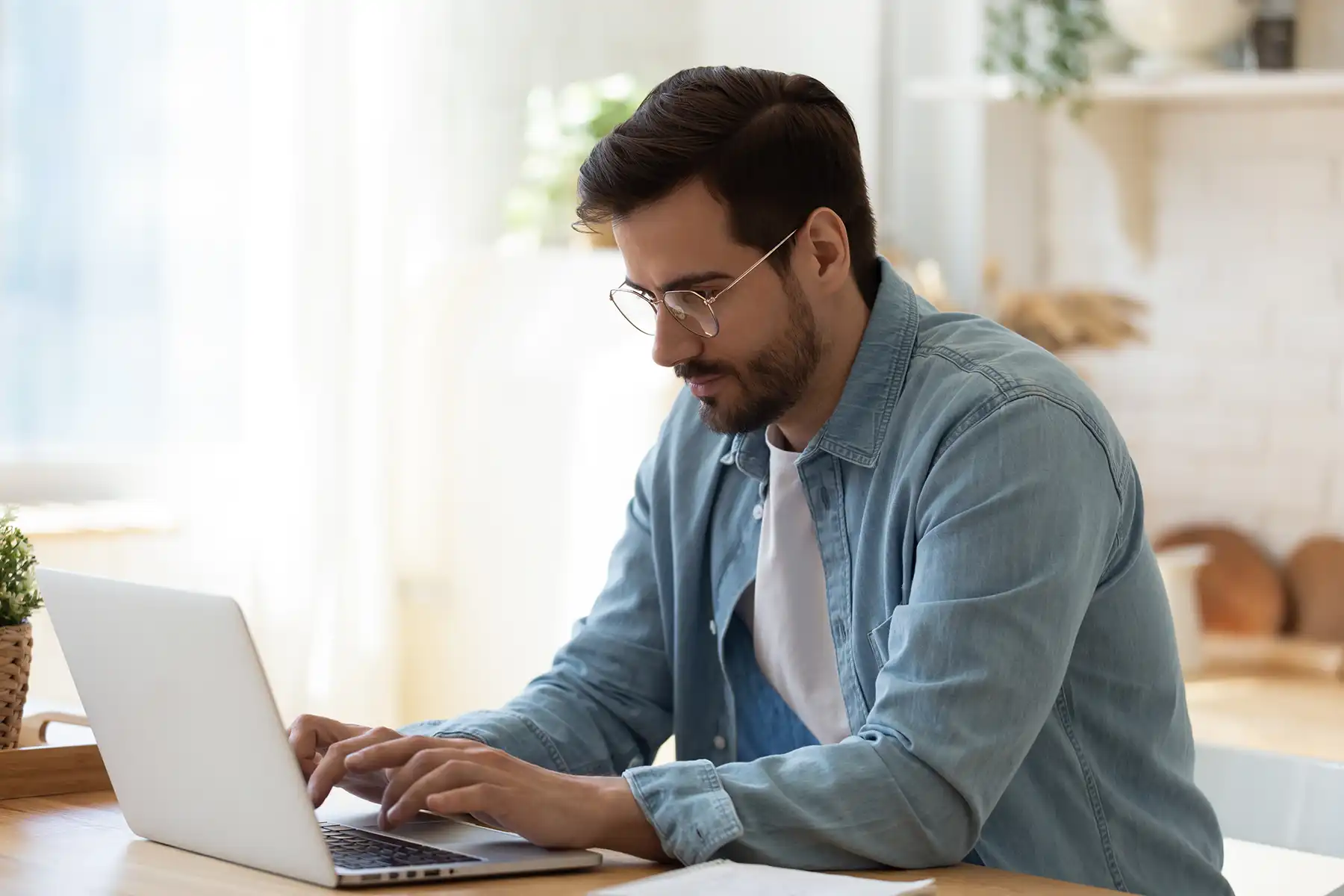 man sitting at a computer typing