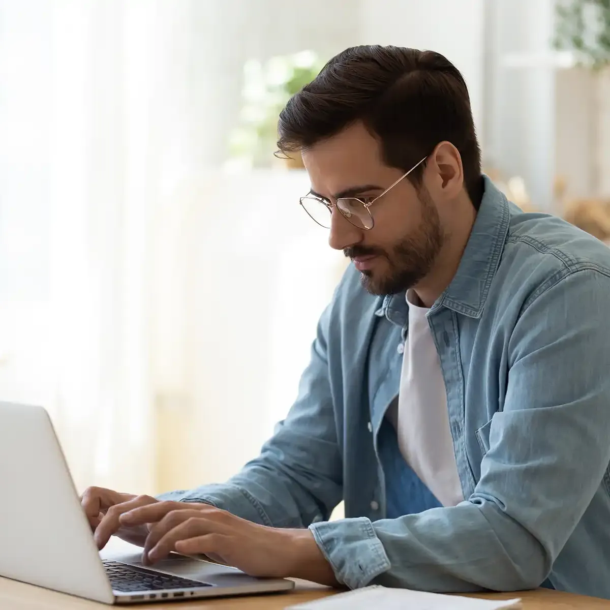 man sitting at a computer typing