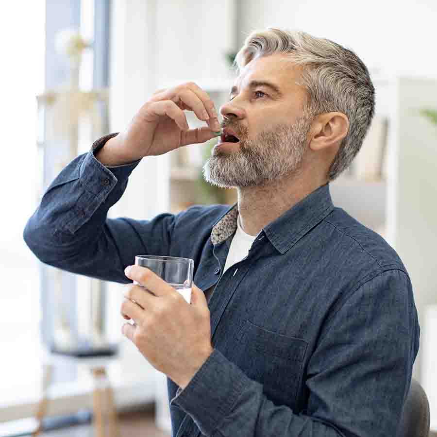 a man taking a pill