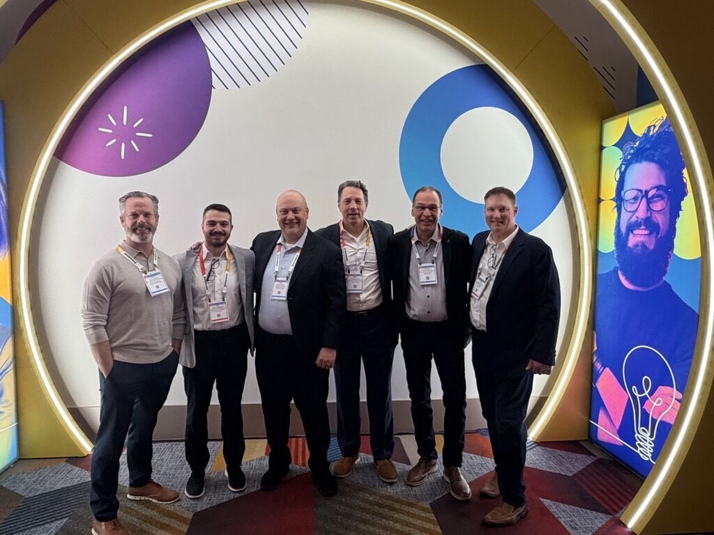 Healthcare team posing in front of a colorful background.
