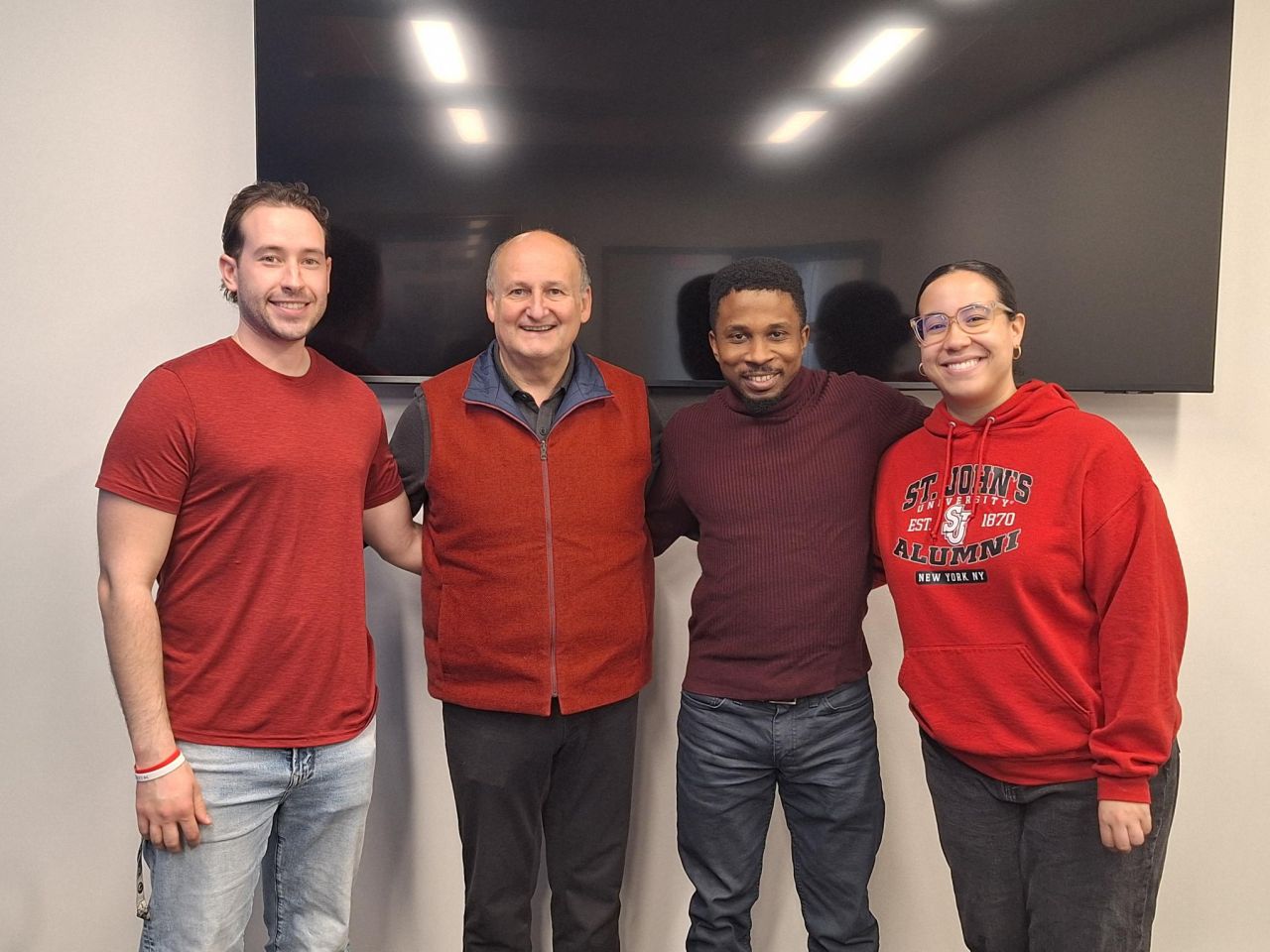 Company members with red outfits.