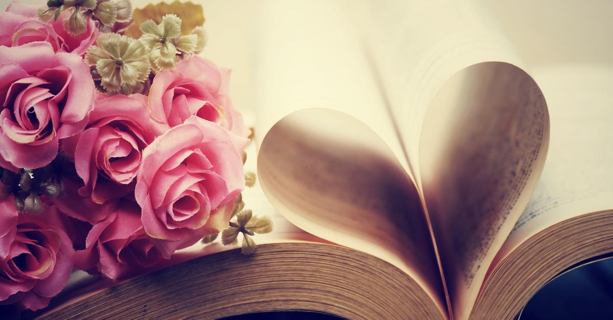 pink roses and book with pages folded in the shape of a heart
