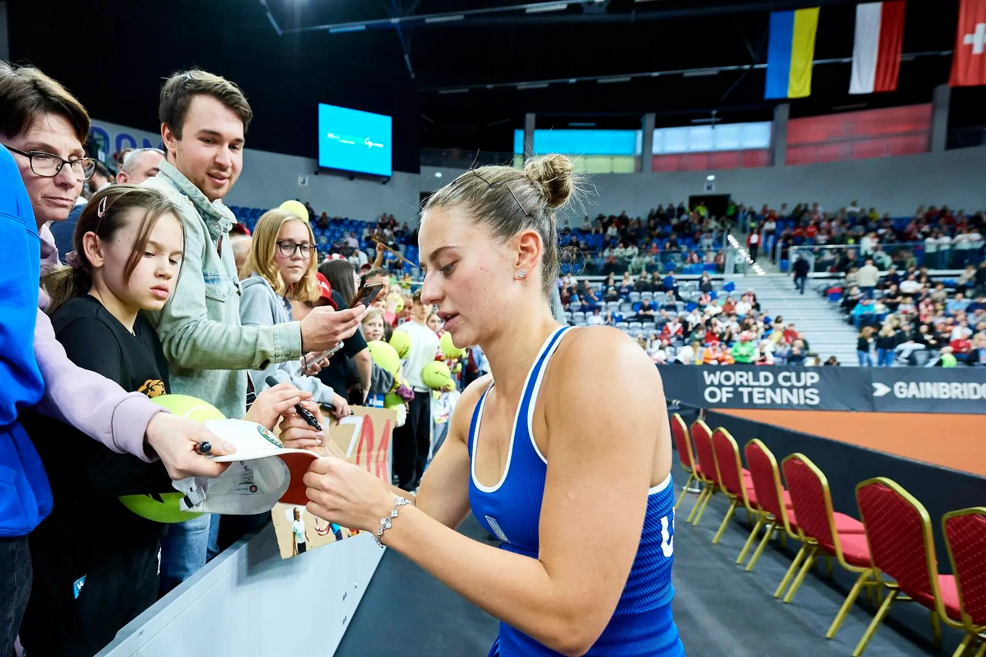 Kostyuk signing hat