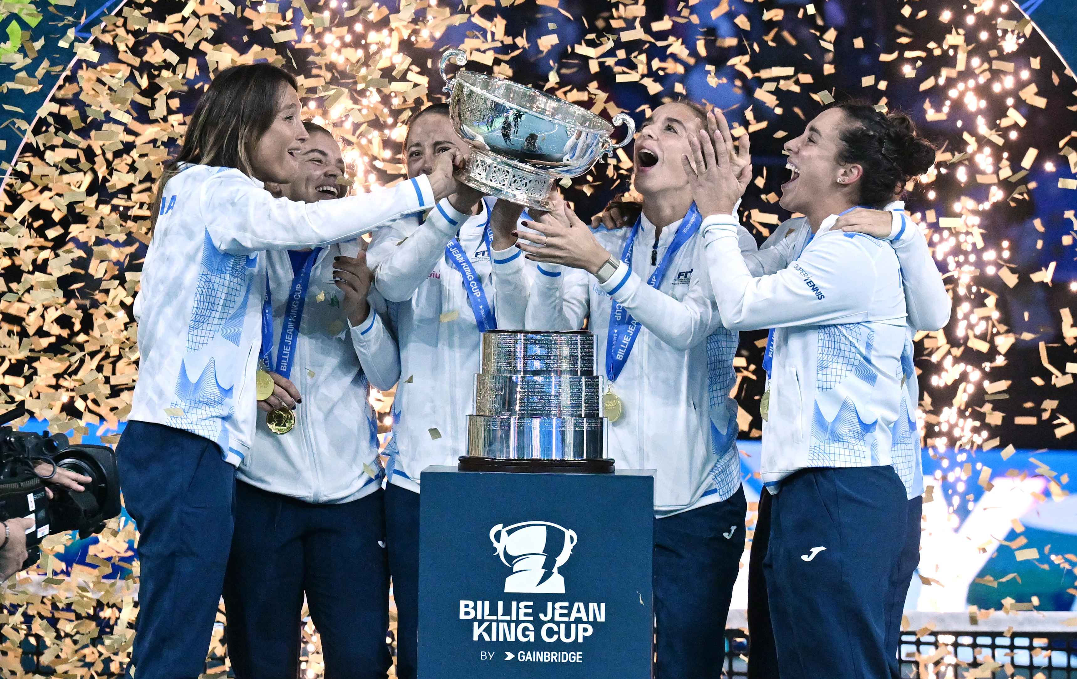 Italy players lift the BJK Cup in 2024.