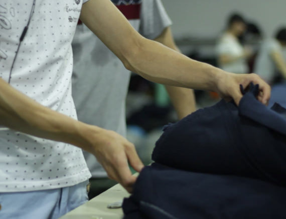 A person inspecting the fabric for colour fastness