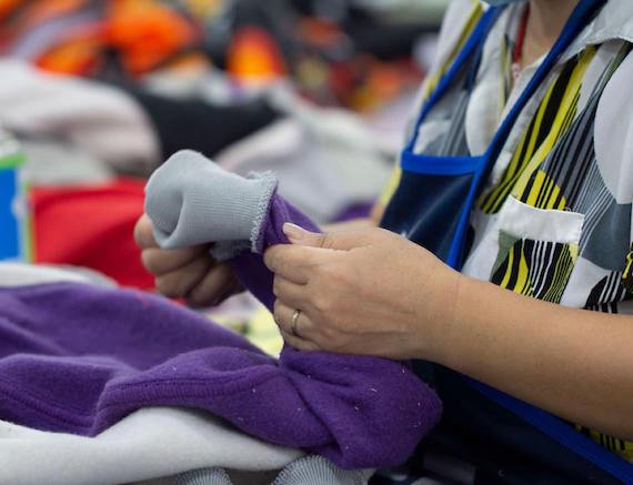 A person inspecting a custom hoodie