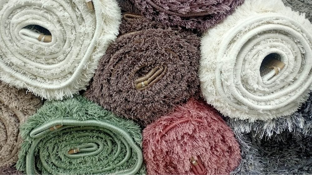 Samples of colorful carpet rolled and stack on top of each other.