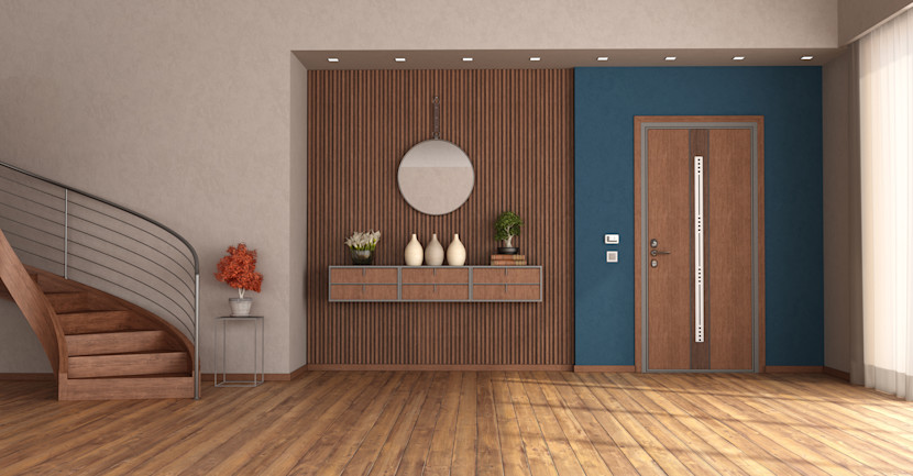 Front hall with wood staircase, wood floor, fluted accent wall, round mirror and open shelf