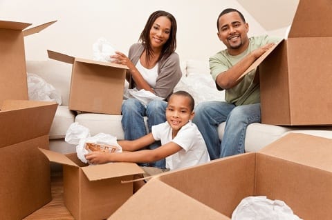 Family of three with moving boxes getting ready for a move