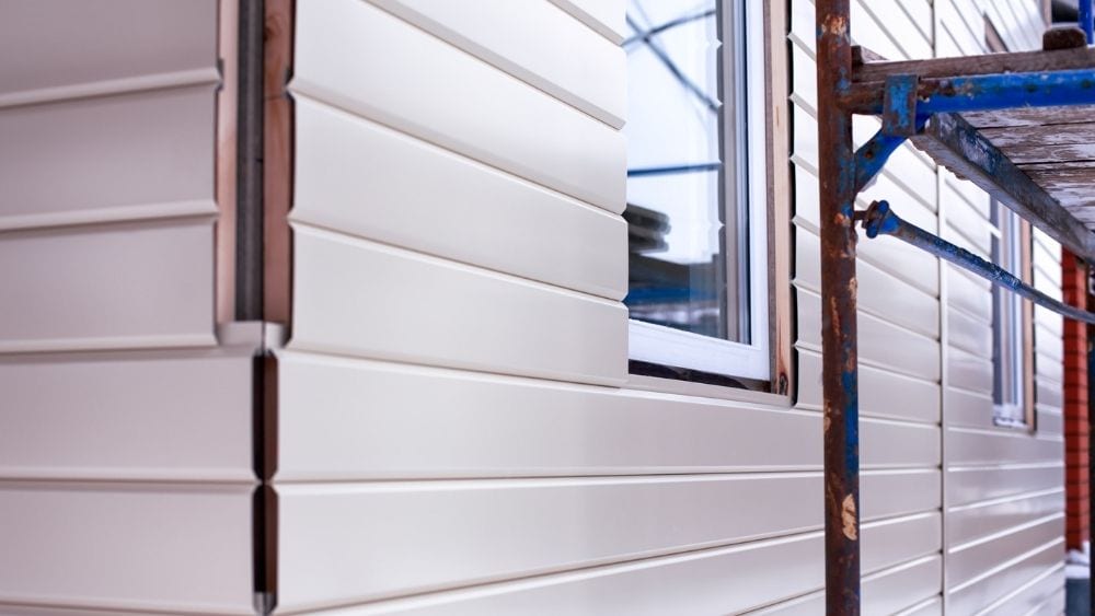 Metal siding being installed on a new home.