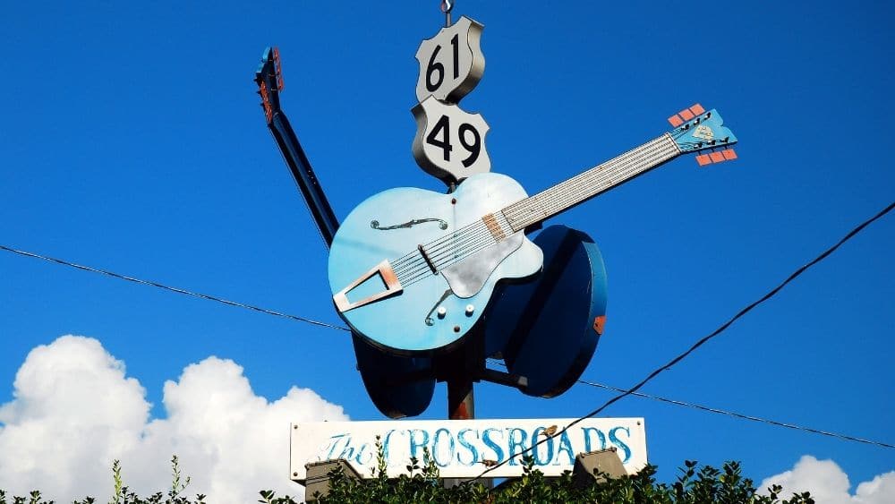 giant sign with guitar that says “The Crossroads” under it in Clarksdale, MS