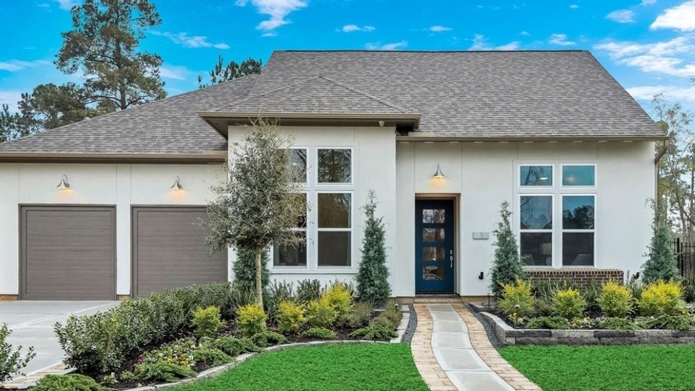 A large brick home with a manicured lawn.