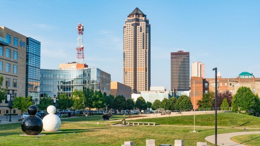 Skyline of Des Moines, Iowa from a park with modern art structures.