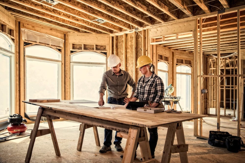 woman-architect-stands-in-frame-of-custom-home-gettyimages-2