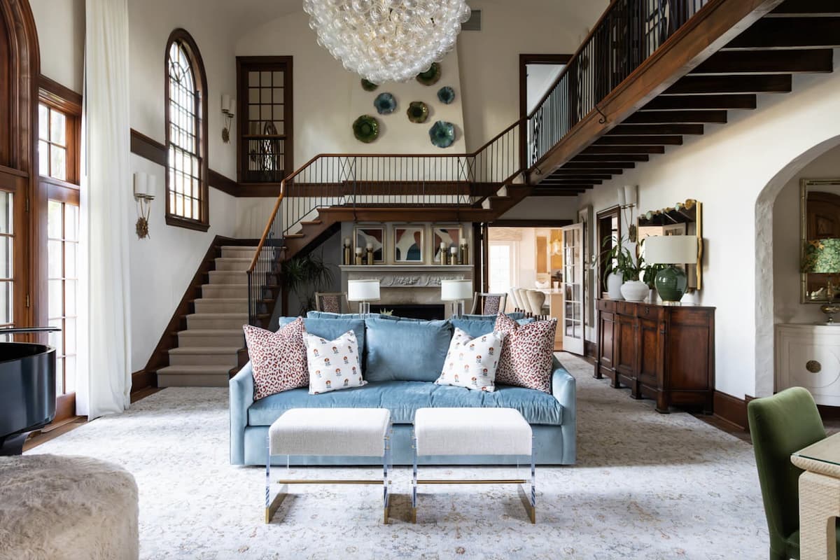 Traditional style house with grand staircase and modern living room furniture