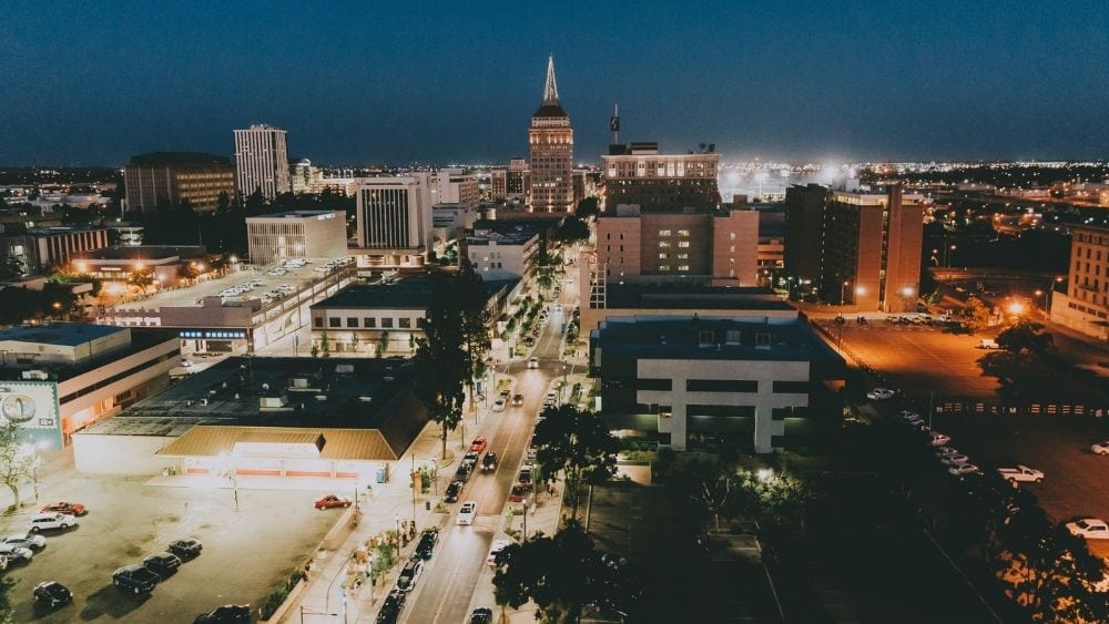 Downtown Fresno at night, lit up with building lights and streetlights.