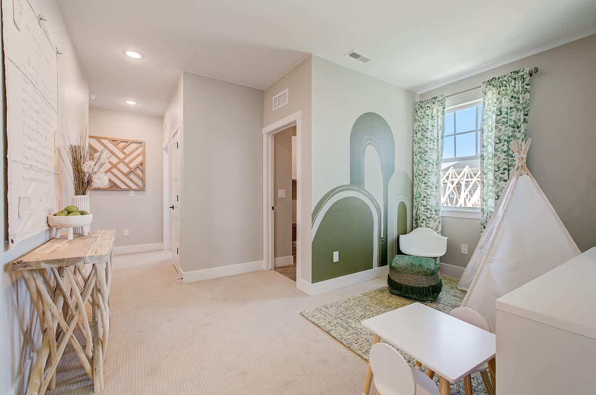 Flex room, turned into a playroom with fun wall mural and kids tent