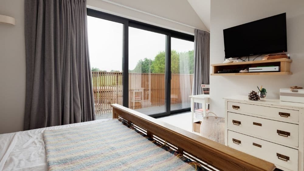 Bedroom with sliding doors leading to the backyard.