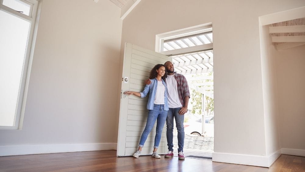 couple standing in the door of their new home