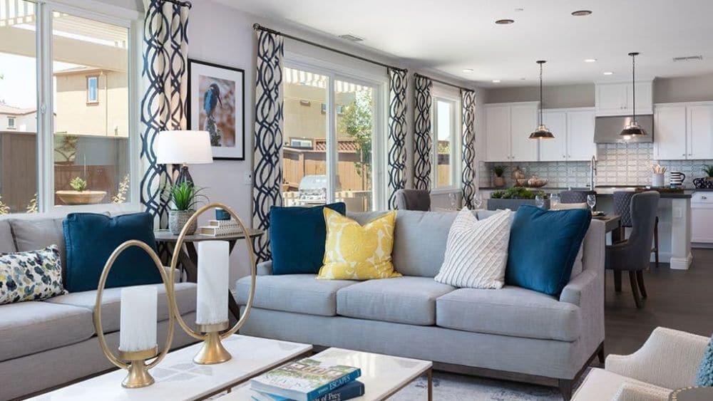 An open-concept great room with lots of windows and modern furniture.