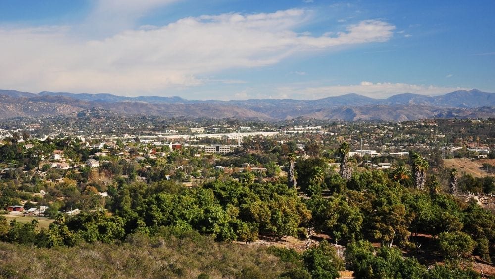 Aerial view of Escondido, a city surrounded by trees.