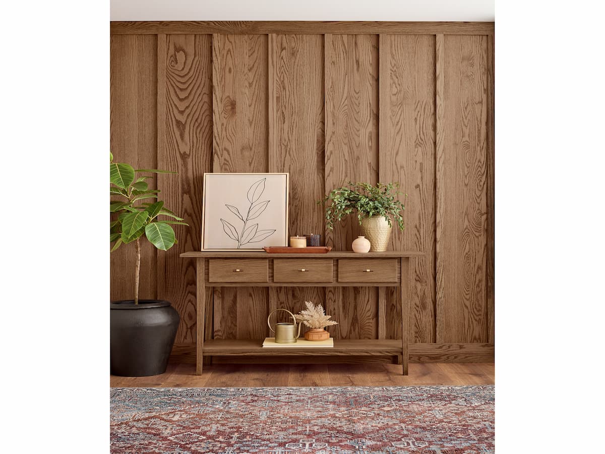 Minwax Stain of the Year for 2026, Special Walnut, shown on a wood accent wall with console table
