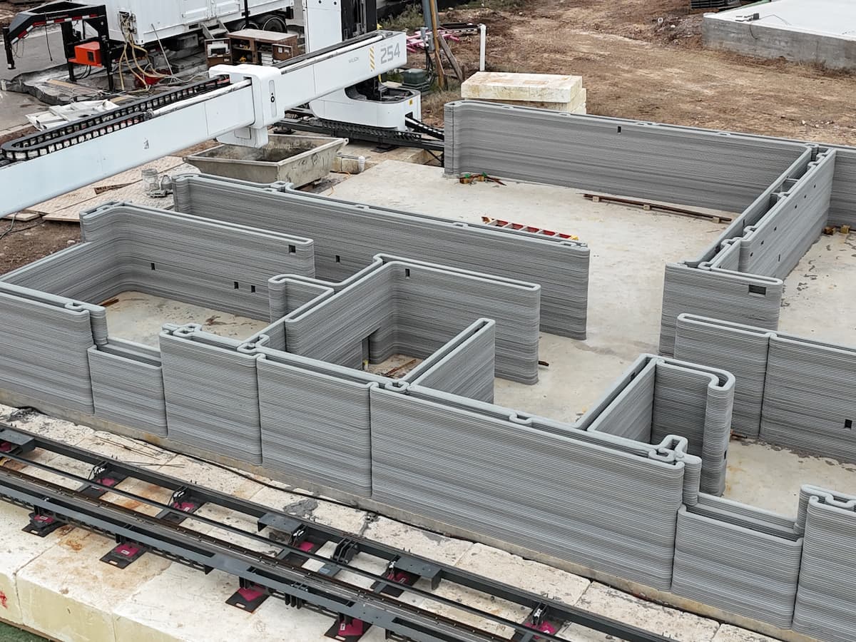 aerial view of 3D printer creating new homes in a residential community