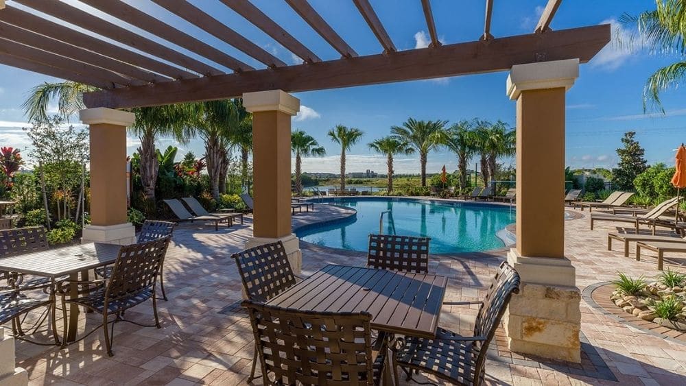 Pavilion over a seating area next to a community pool.