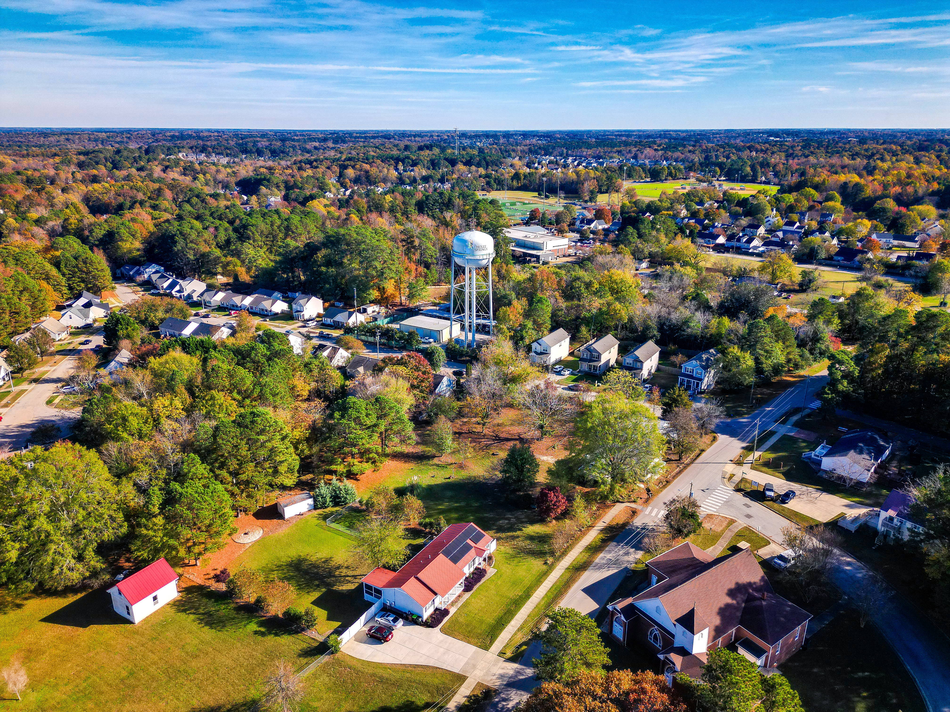 aerial view of a town with a water tower and homes