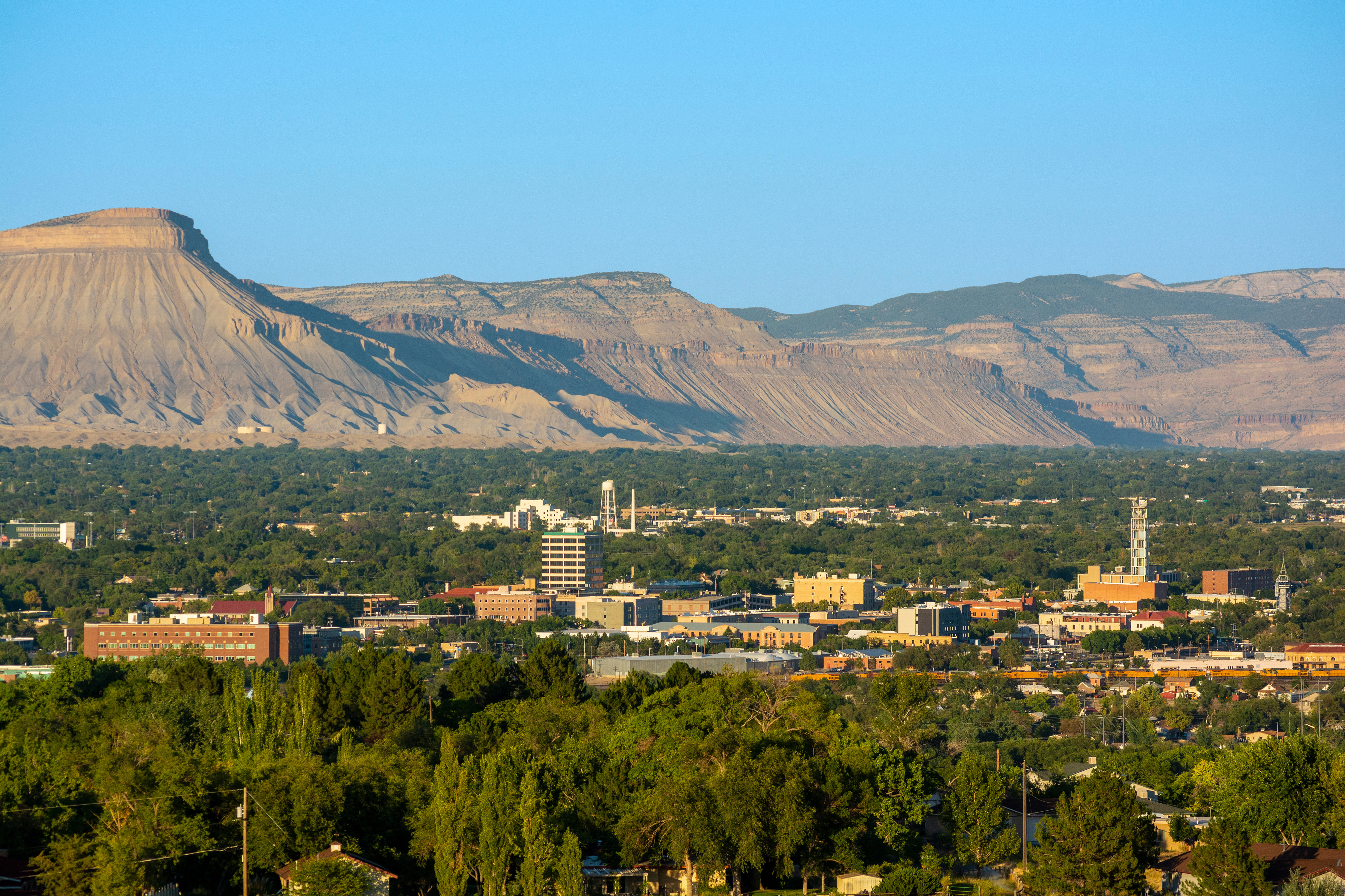 Sunny day overlooking downtown Grand Junction with mountains in the background