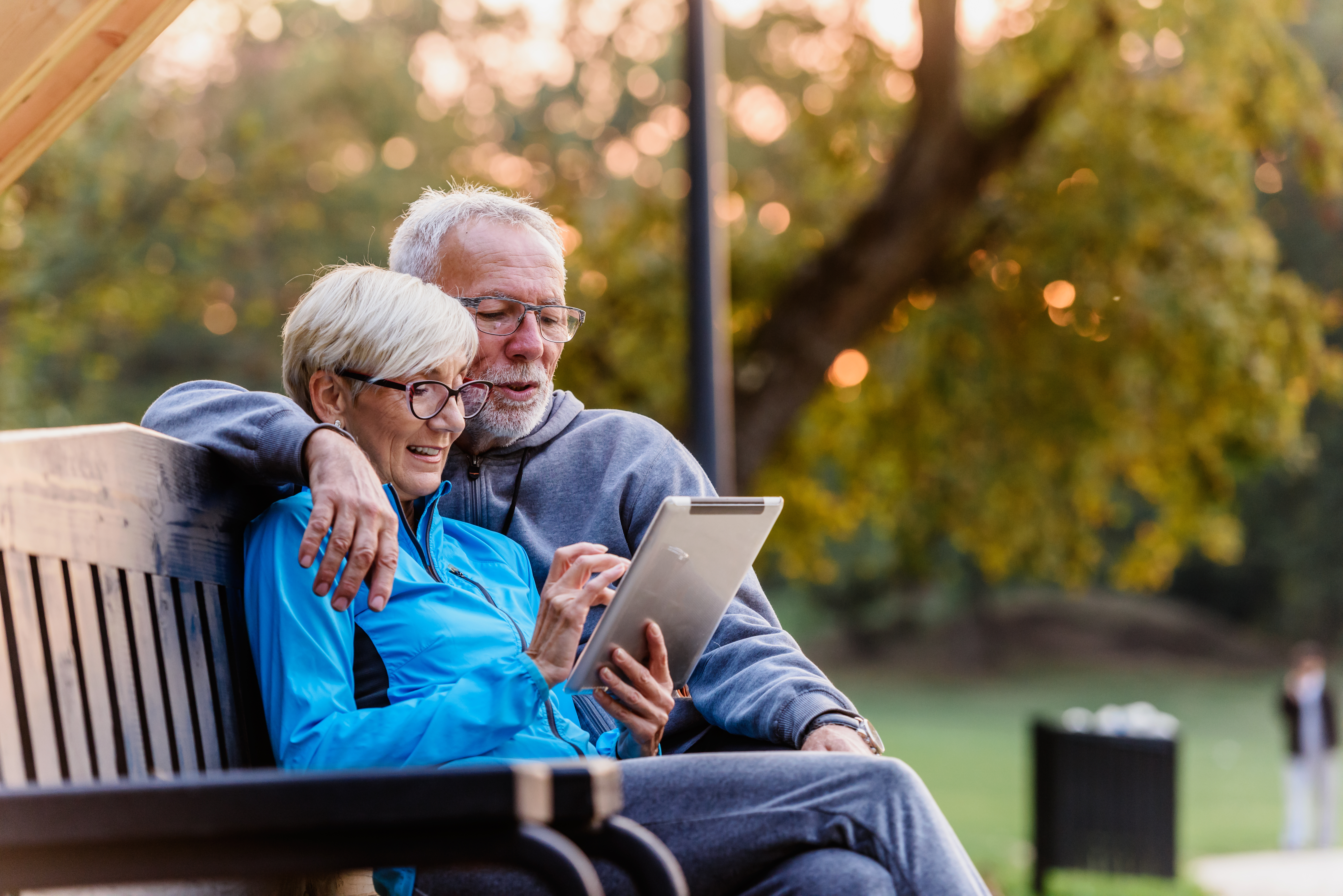 senior-couple-looking-at-tablet