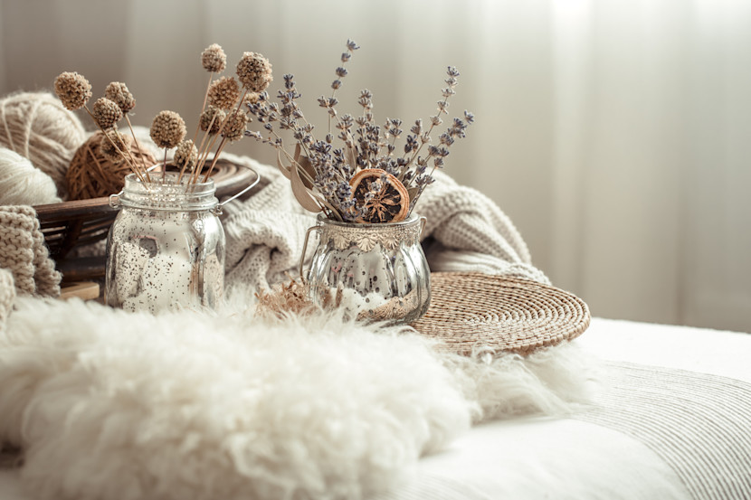 White faux fur blanket folded on a chair, with monochromatic accessories nearby