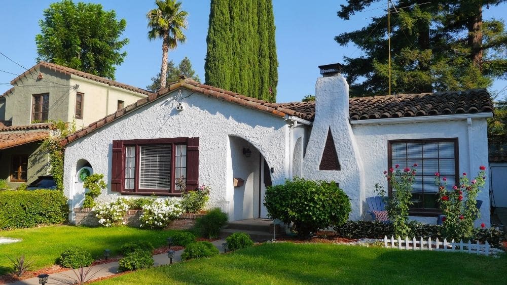 White stucco house with green lawn.