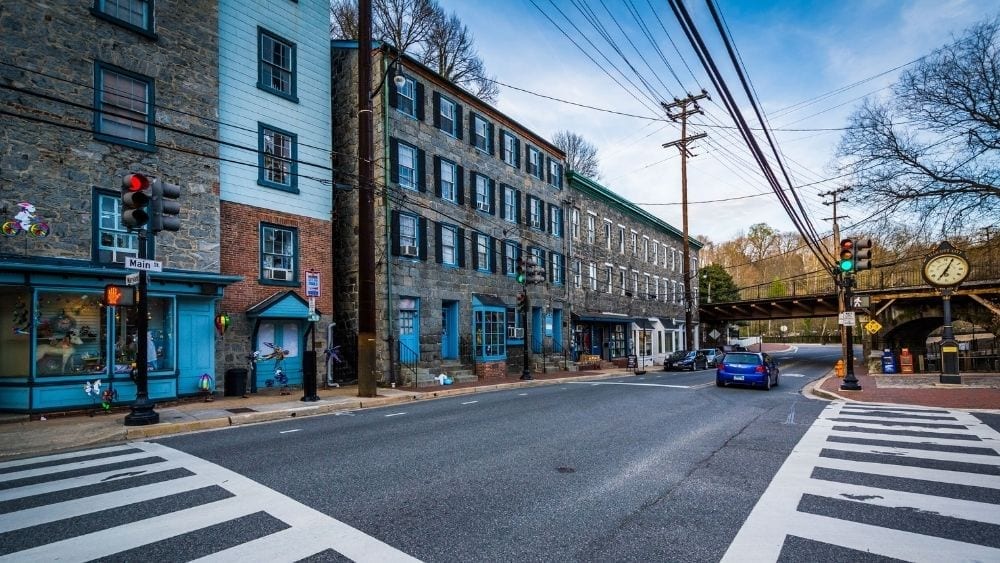 A downtown crosswalk where old brick buildings line one side of the street.