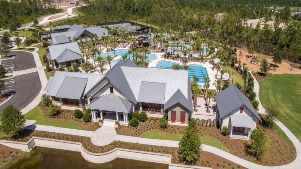 View from above of a community pool and large building.