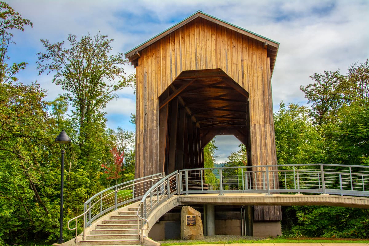 Light wood, tall covered bridge with walkway