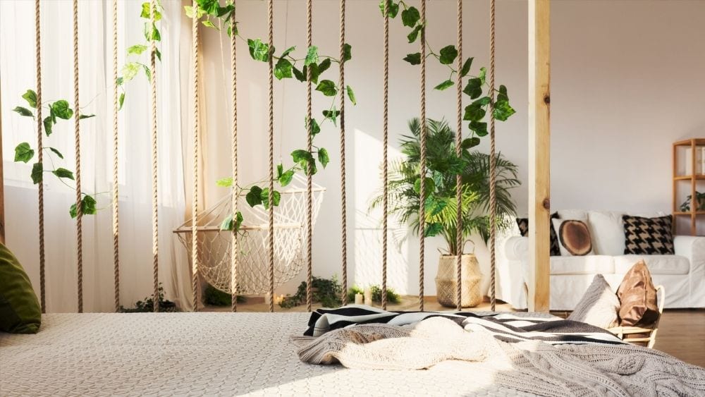 A room divider made from wooden beams and rope.