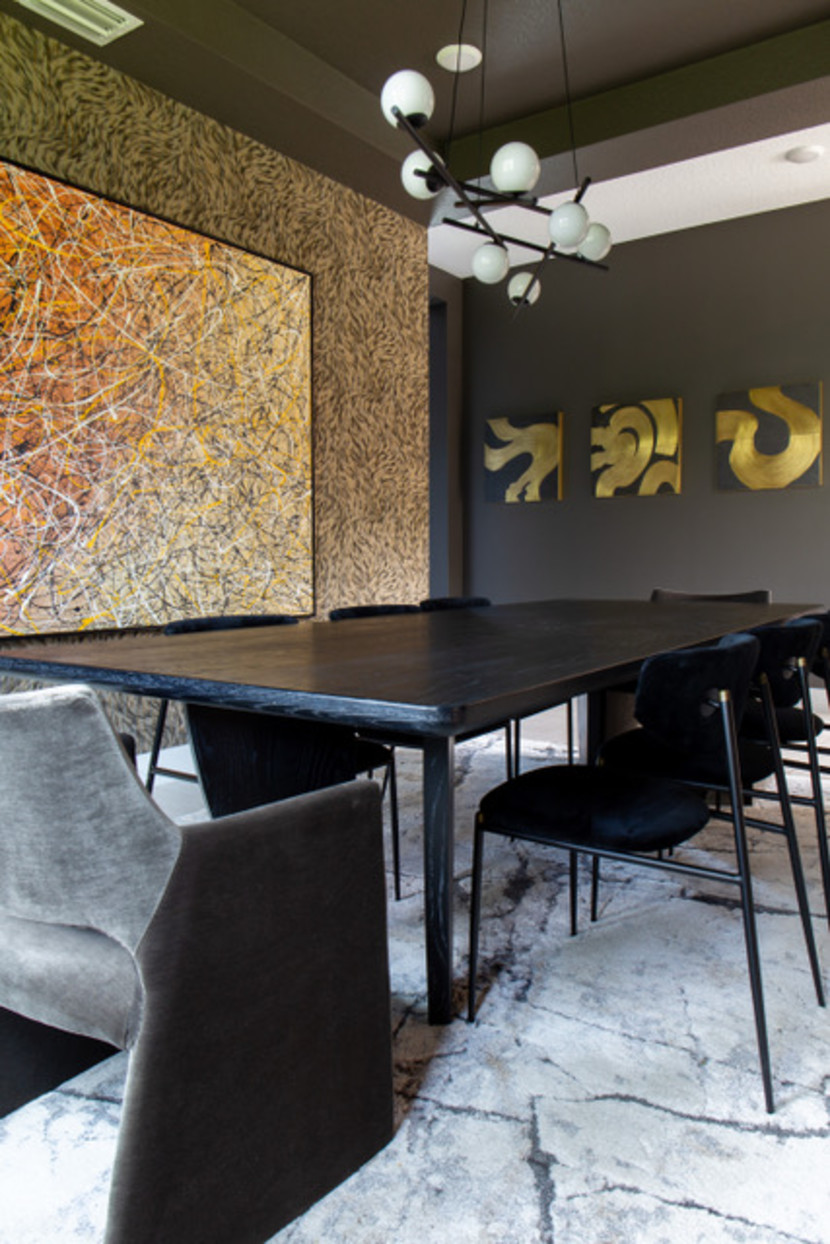 Textured, wallpaper wall, with globe light fixture, green walls, grey carpet and black lacquer dining table.