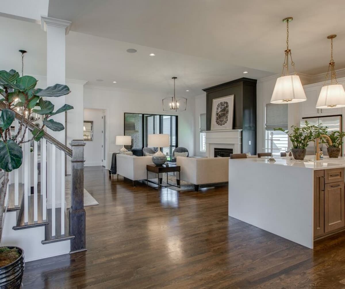Open concept living room and kitchen, with fireplace focal point