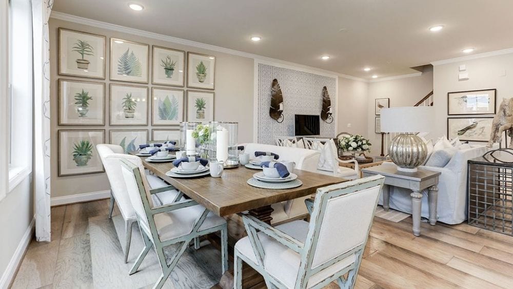 A modern open-concept dining and living room, fully furnished and decorated.