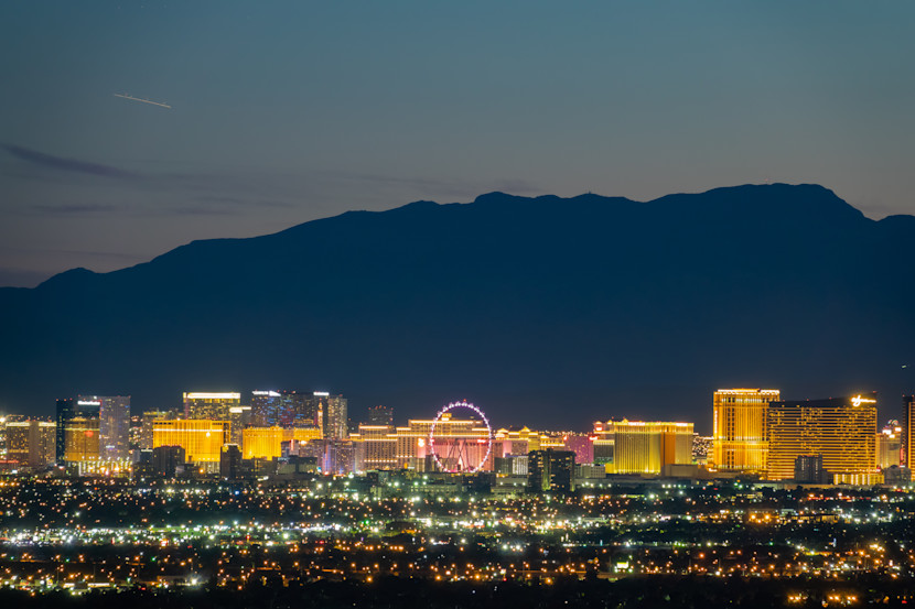 Shot of Las Vegas strip from far away at night, with mountain in background