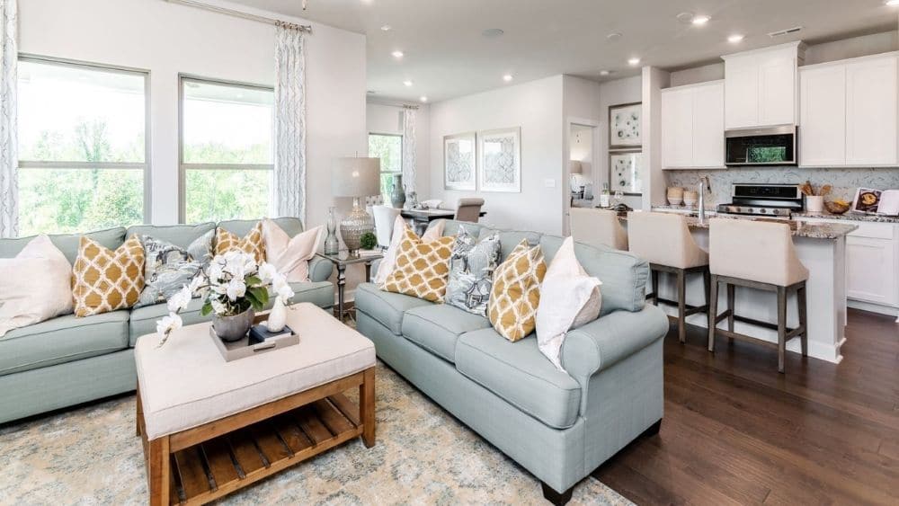 Modern open concept living room that leads into a bright and airy kitchen.