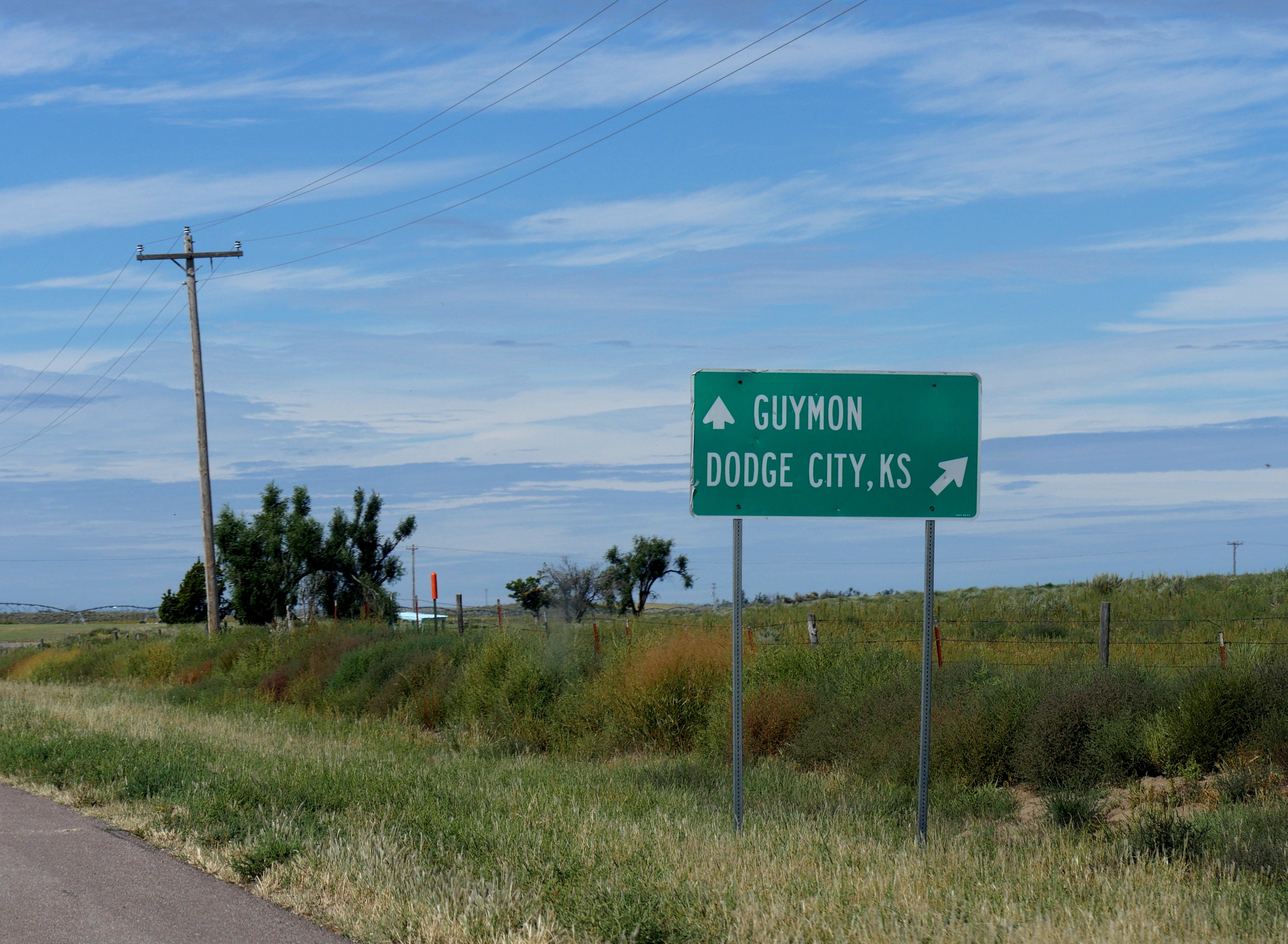 highway sign along road giving direction to Guymon and Dodge City, Kansas