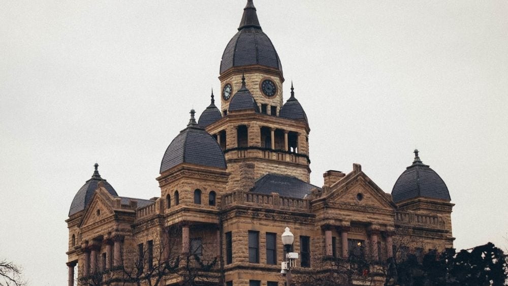 An old court house building made from limestone with iron turrets.