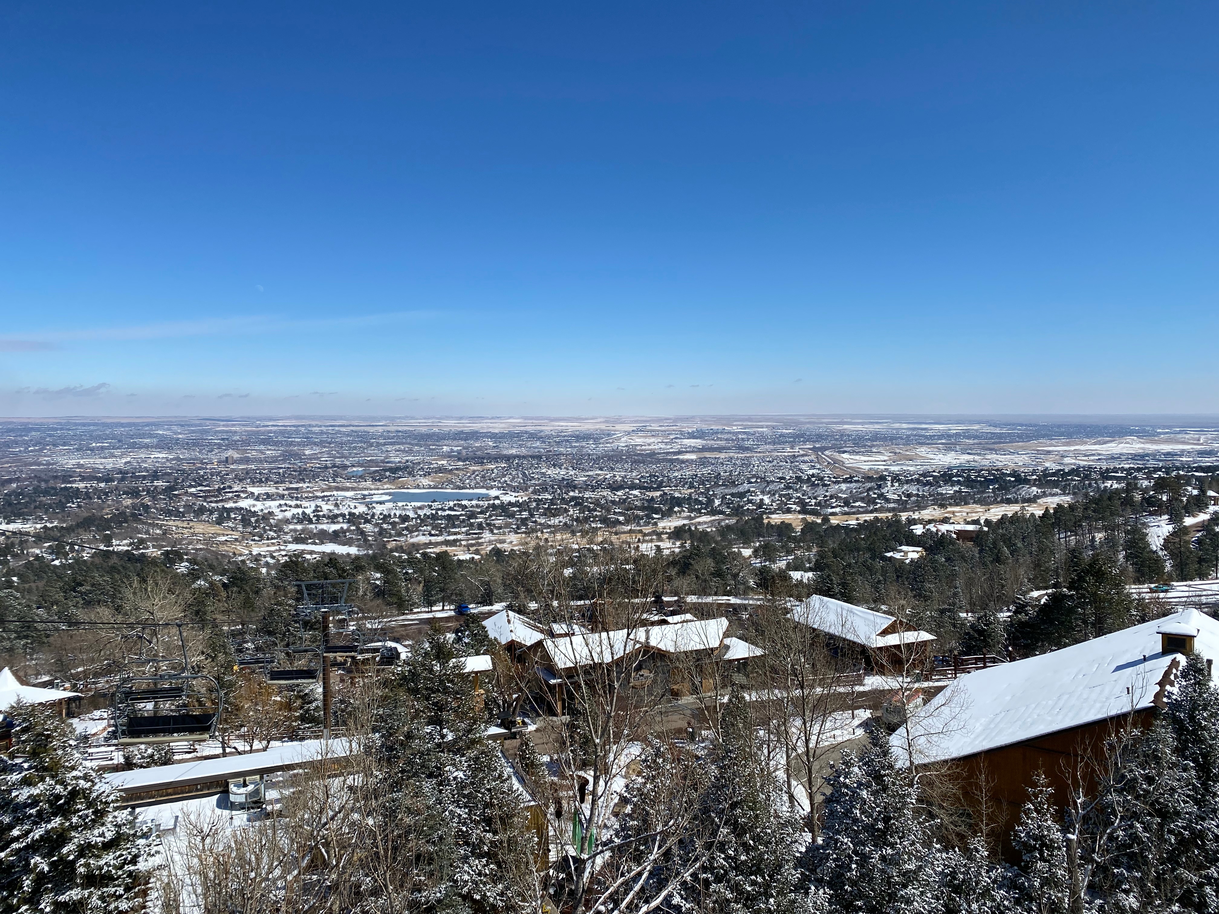 View from the top of Cheyenne Mountain Zoo overlooking snowy valley and city below